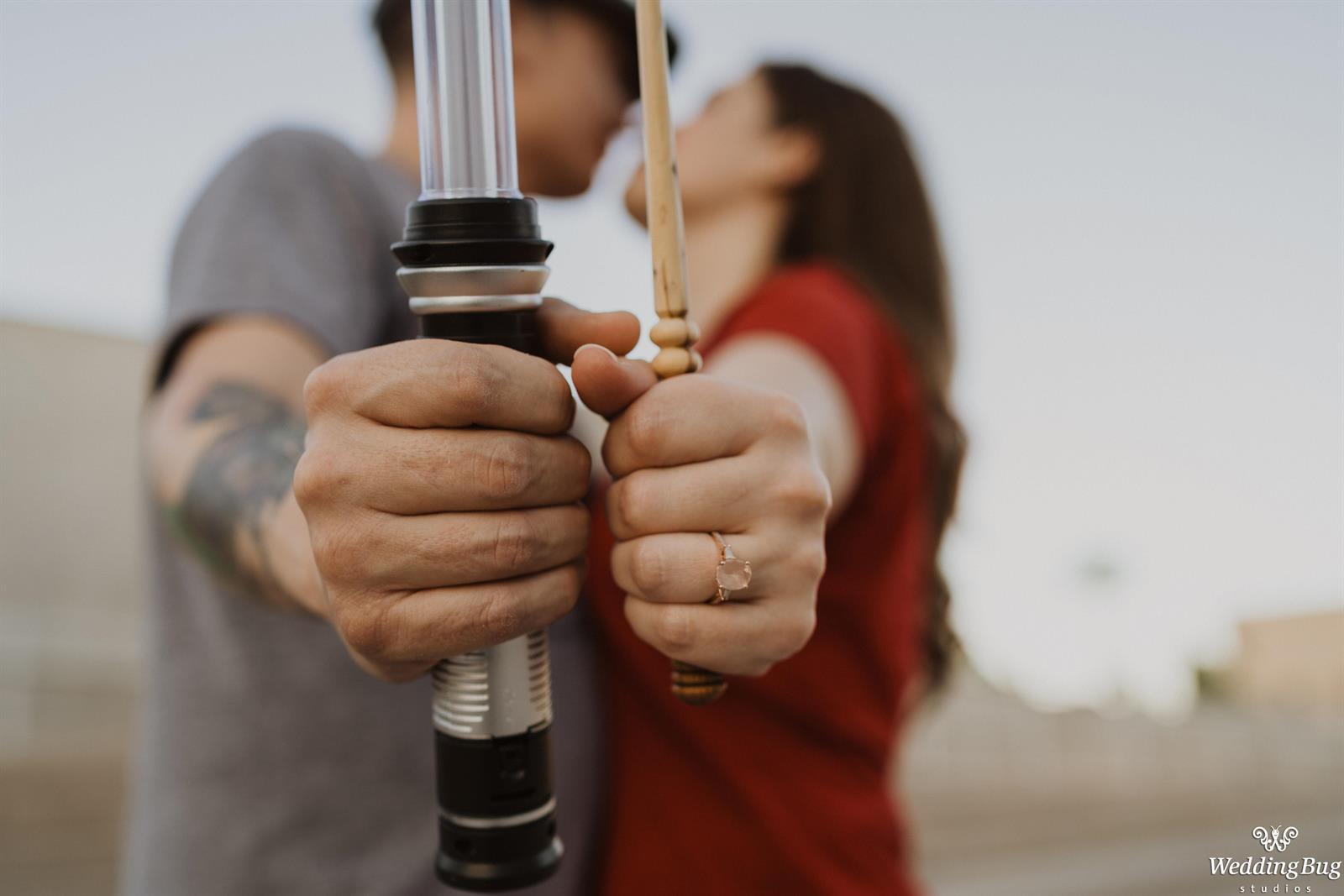 Quirky Engagement Photo Lightsaber vs Wand